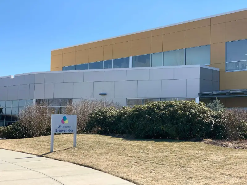Grace School Campus building entry with sign reading "Bienvenidos / Welcome"